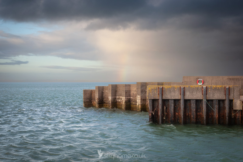 Drummore Harbour Wall with hint of rainbow