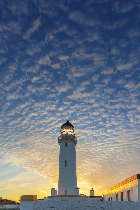Dawn at the Mull of Galloway Lighthouse with broken clouds